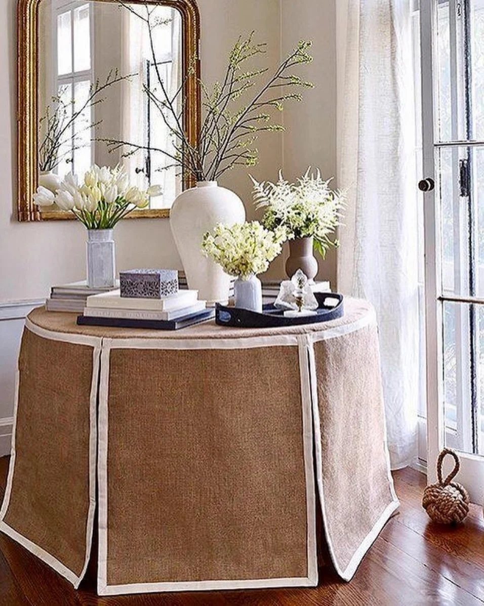 Brown and white flat panel skirted table in foyer.