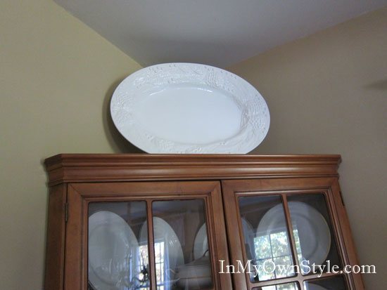 How to add height to decorative items on top of wall cabinets and hutches.