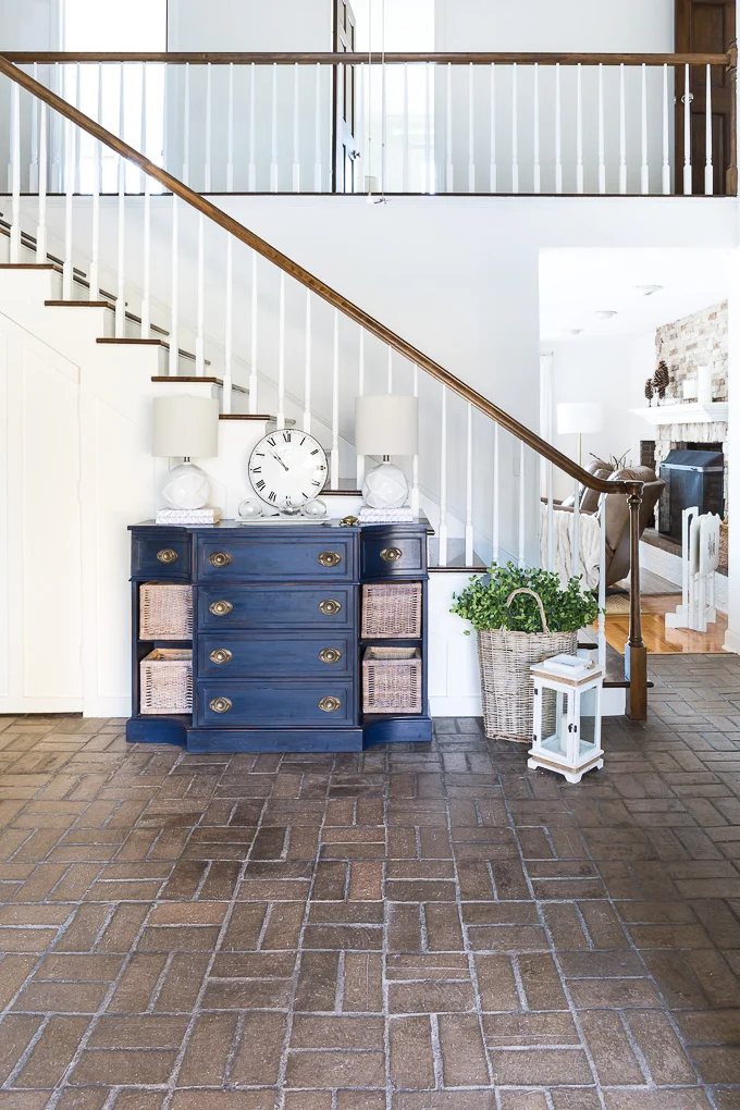 Looking from entryway of house into brick floored foyer.