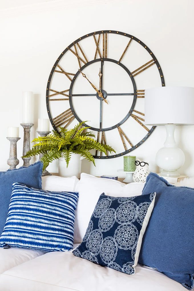 How to arrange long stem fake flowers in a glass vase in living room decor