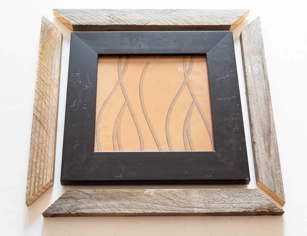 Cut scrap book to place around intact thrift store frame to make the frame larger.