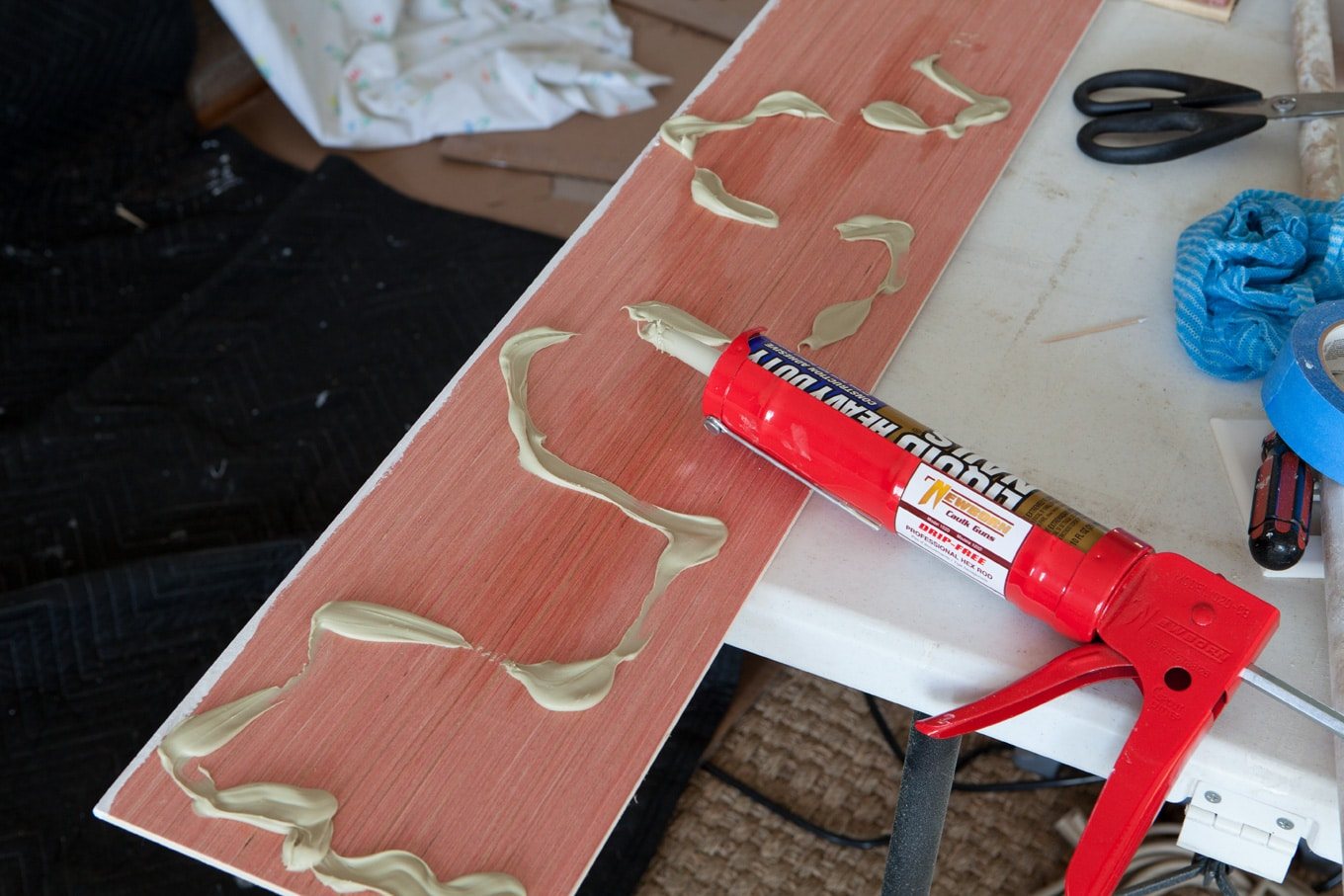 How to attach wood plank panels to a brick wall