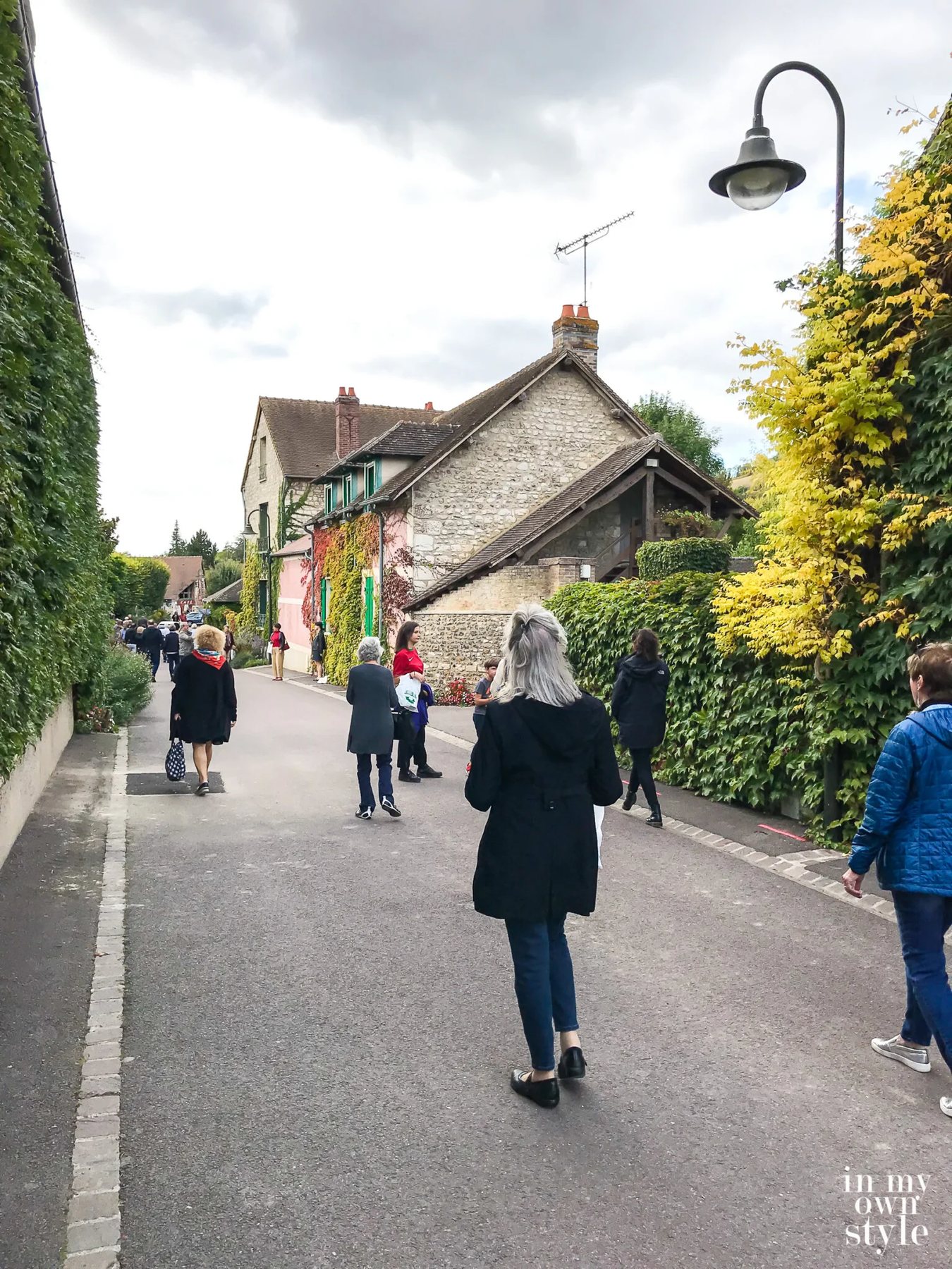 Tourists walking along a road in Giverny France
