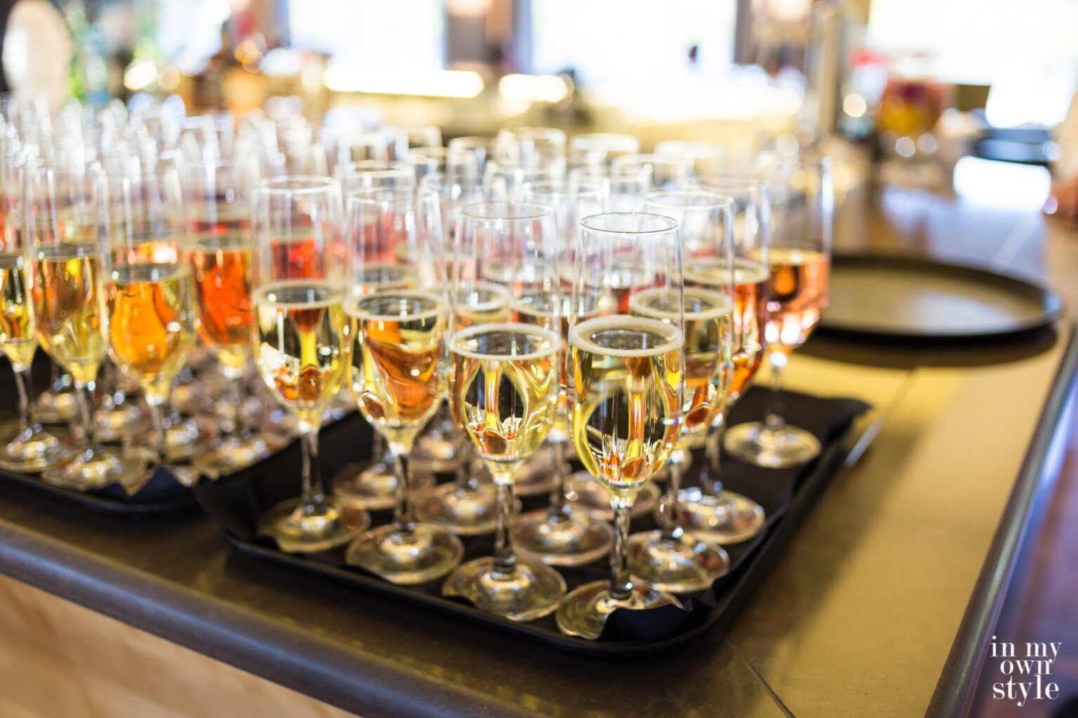 Glasses of Champagne on trays on ships bar.
