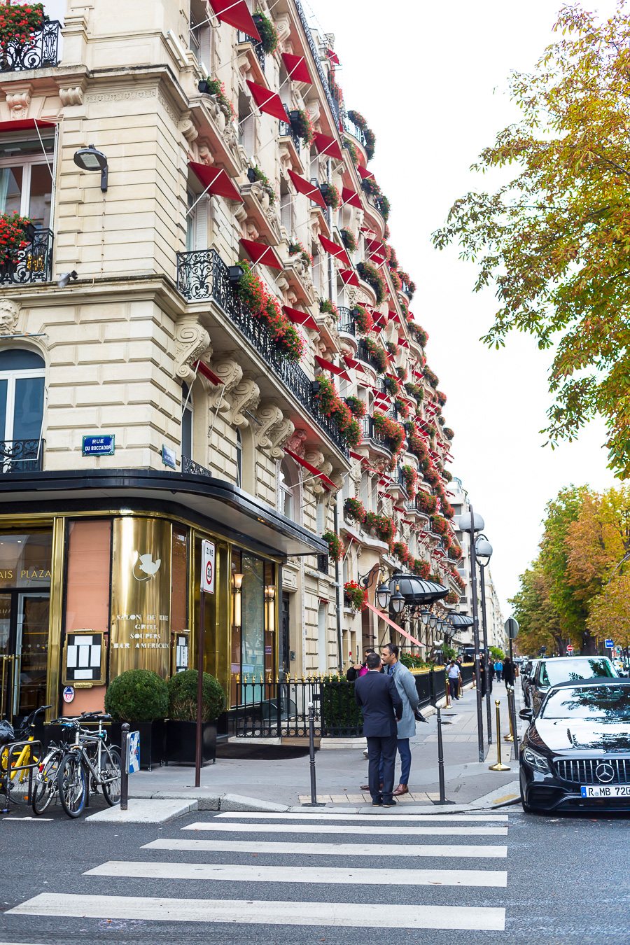 Paris apartment building with red awnings.