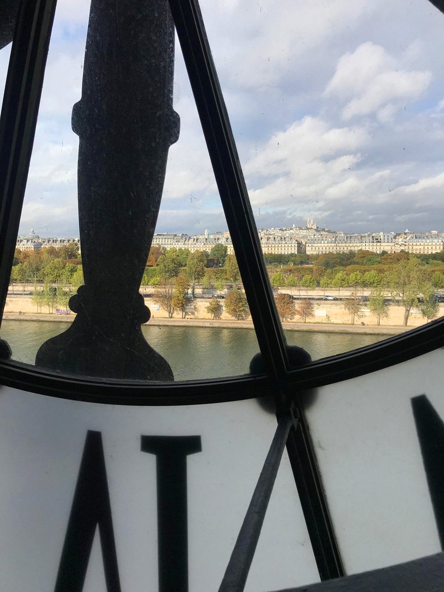 Looking through the large Roman numeral clock at the Museum D'Orsay in Paris.