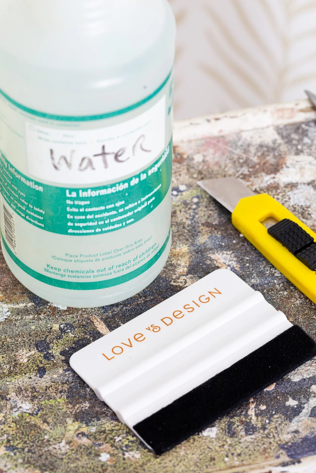 Close up of Supplies needed to install Love vs Design wallpaper.