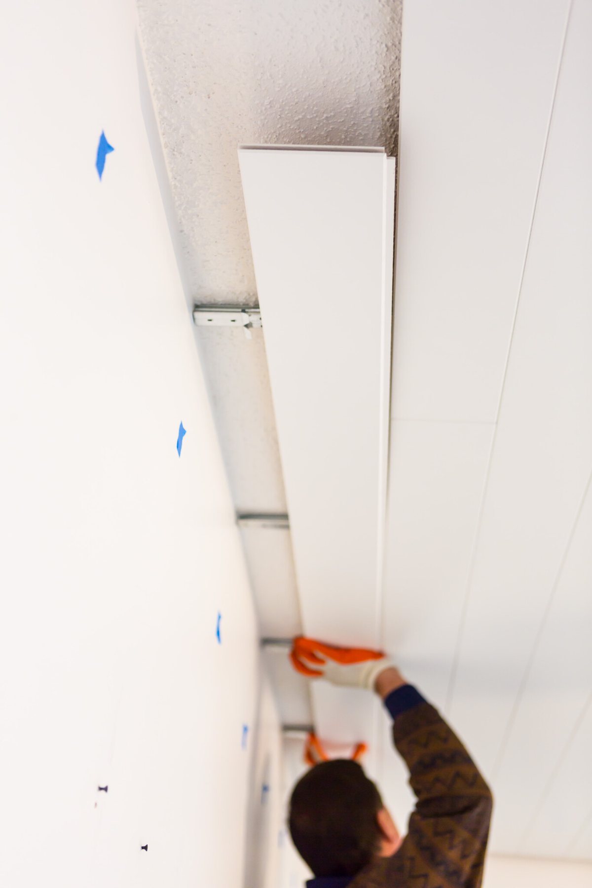 Painted White Armstrong WoodHaven Planks covering a popcorn ceiling.