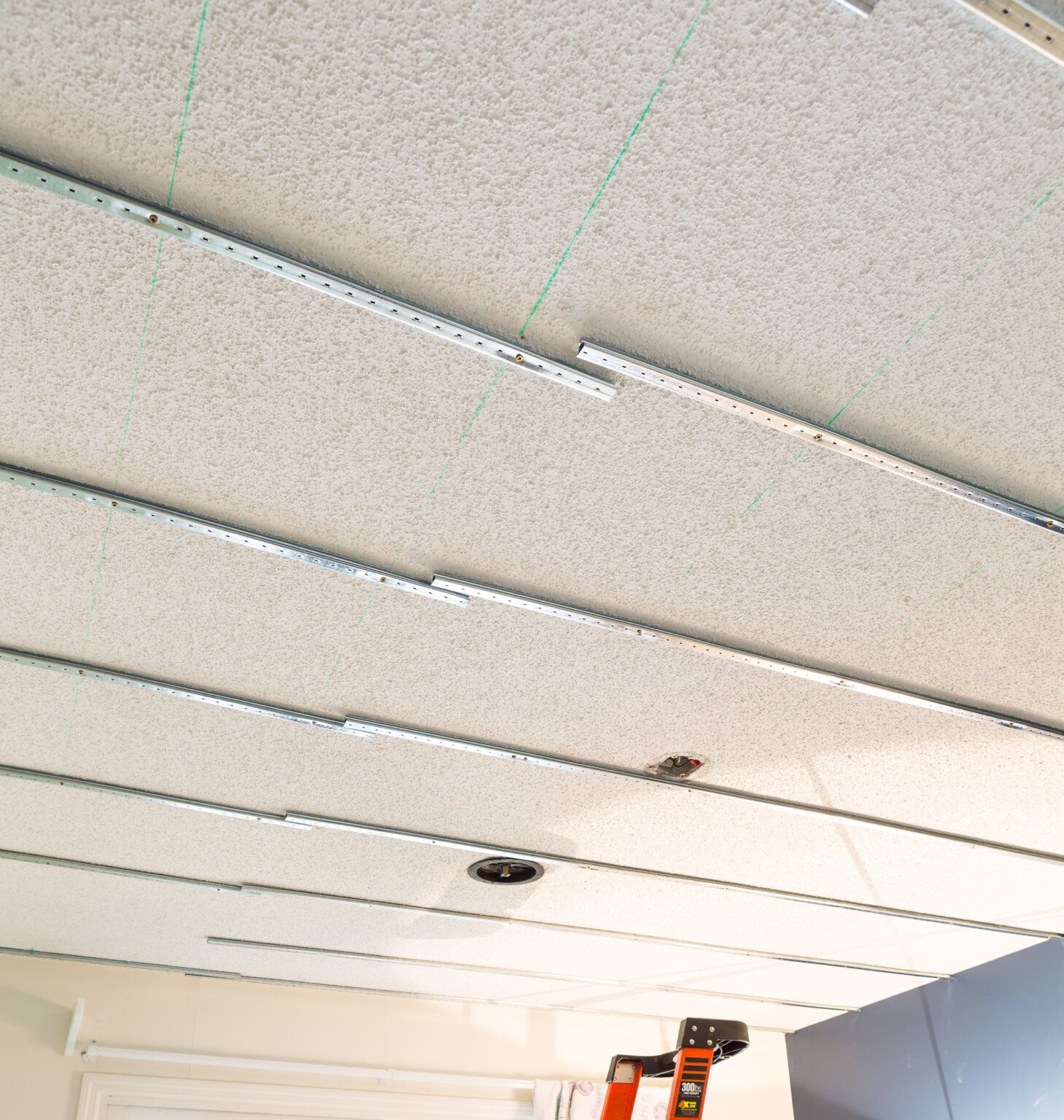Popcorn ceiling cover up ideas DIY using the Armstrong Easy Up tracks, clips and planks.