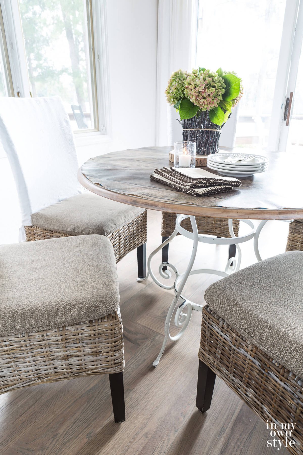 Up close image of new dining chair cushion covers made by repurposing fabric from a broken outdoor umbrella.