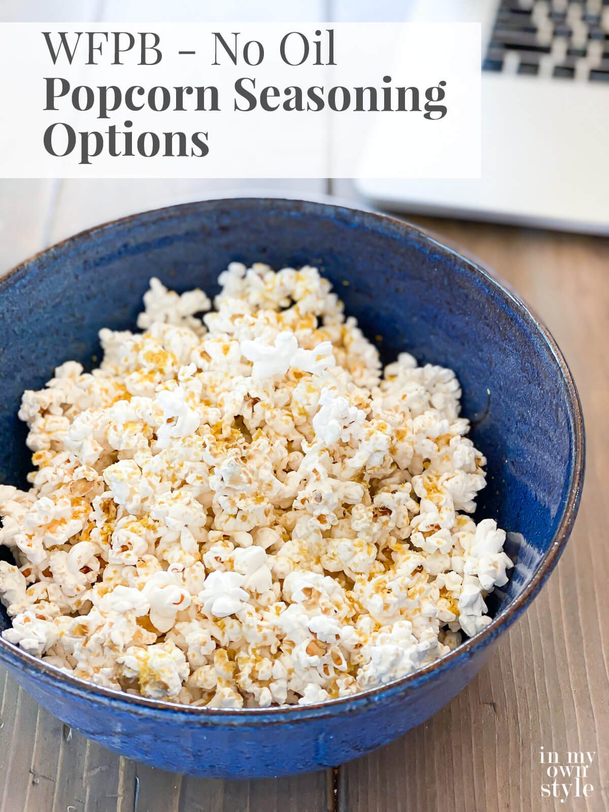 Bowl of No Oil Air popped popcorn with plant based seasoning on it. Text overlay says WFPB No Oil Popcorn Seasoning Options