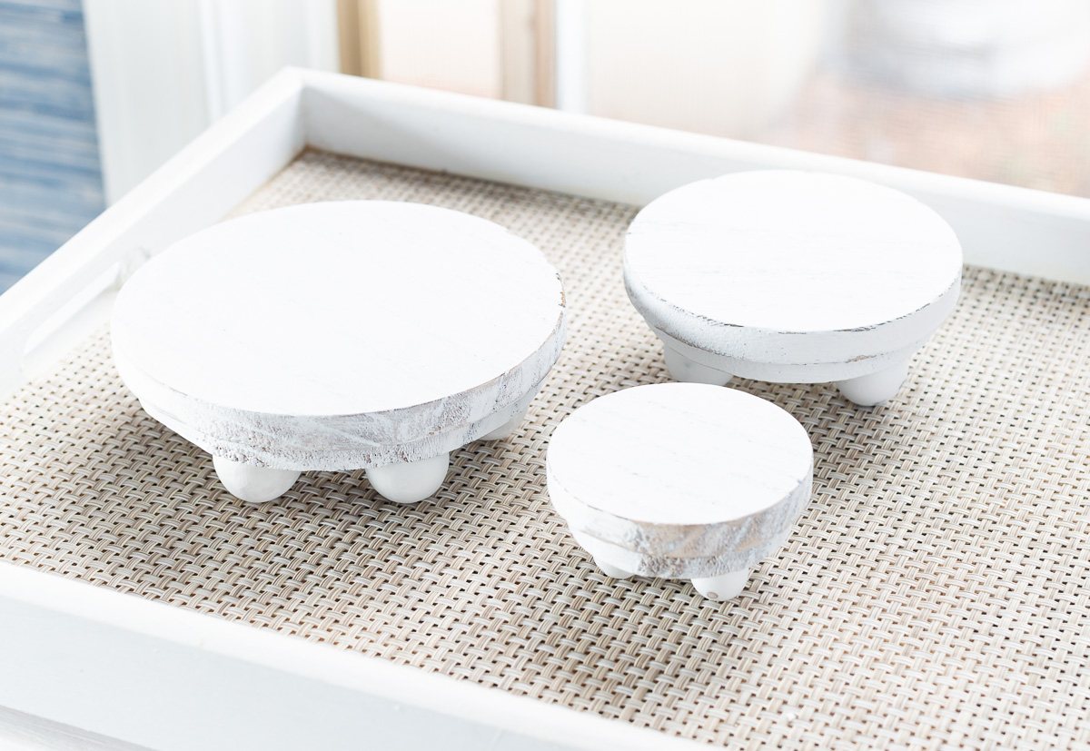 3 wood risers that can be used to add height and focus to decor displayed on tables and kitchen counters.