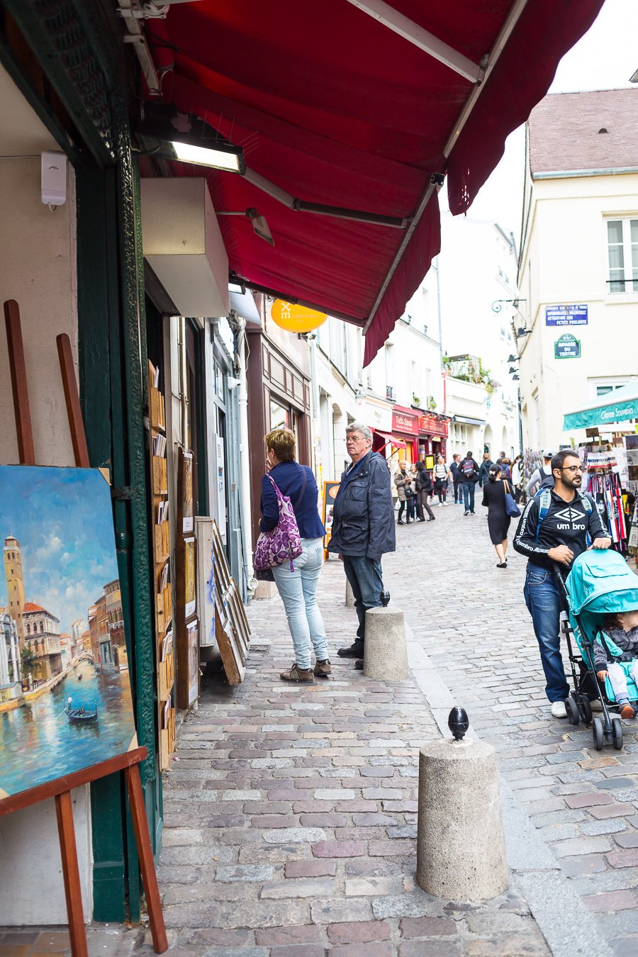 Art for sale on a cobblestone street in Paris