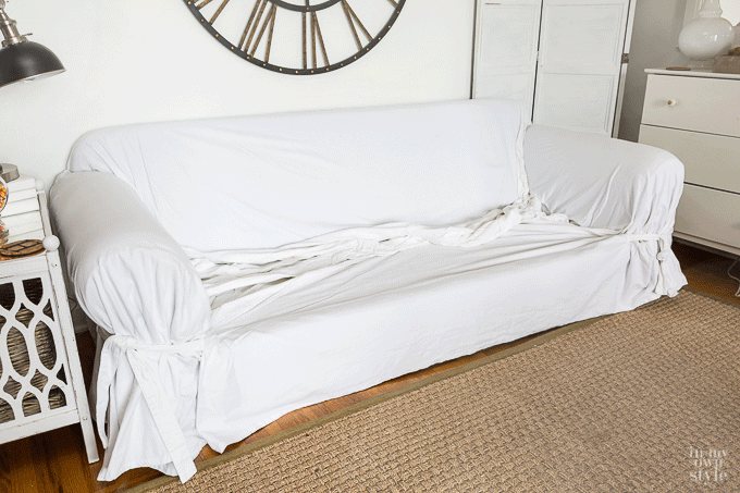 How to easily put a throw style slipcover from Pottery Barn on a sofa