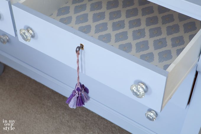 Lined dresser drawer with blue and white gift wrap