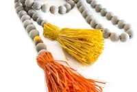Craft Your Own Driftwood Bead Garland Featuring Colorful Raffia Tassels