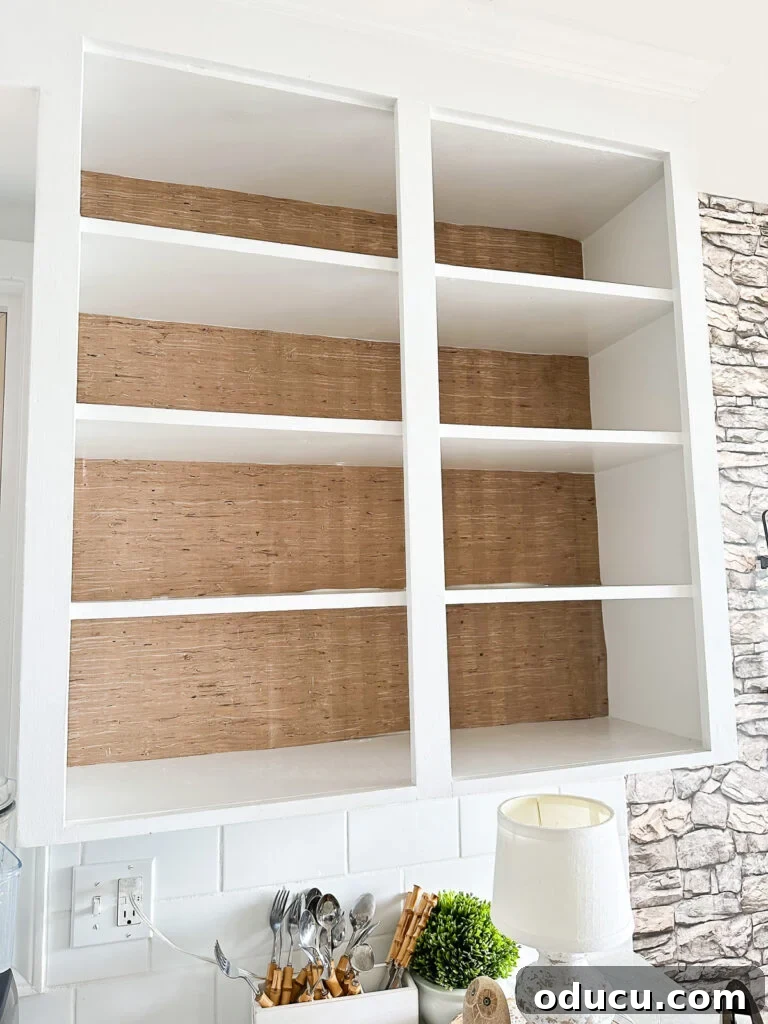 Unveiling Our Open Kitchen Wall 15 Open kitchen shelves featuring grasscloth wallpaper on their backs, creating a beautiful contrast and adding decorative interest, especially styled for the fall season.