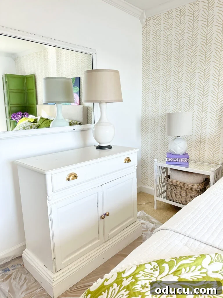 White painted sideboard in a bed room after it was swapped from another room in the house. The cabinet finds a new purpose, demonstrating the power of furniture swapping.