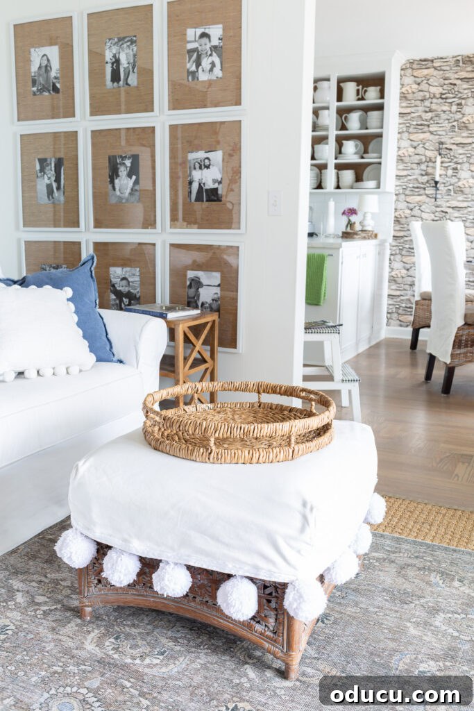Round rattan tray on white slipcovered ottoman.