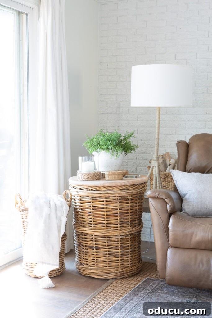 Large wicker basket made into a side table next to a driftwood colored recliner chair.