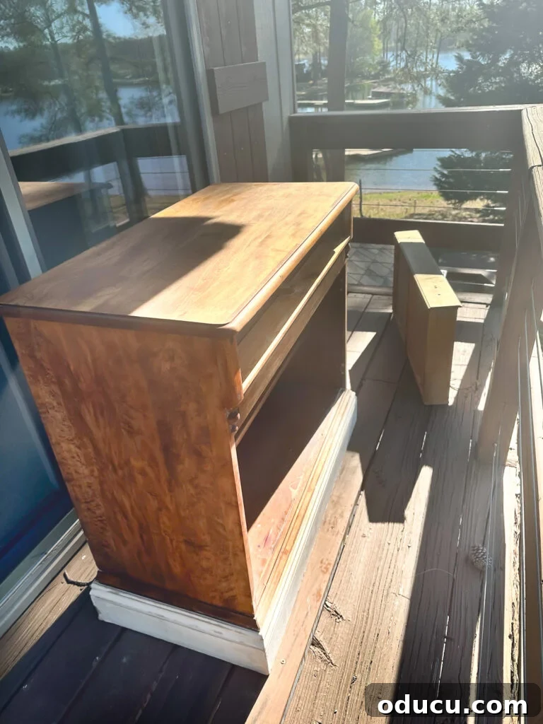 The Transformed Cabinets 3 paint stripped wood cabinet placed outdoors in morning sun for natural bleaching