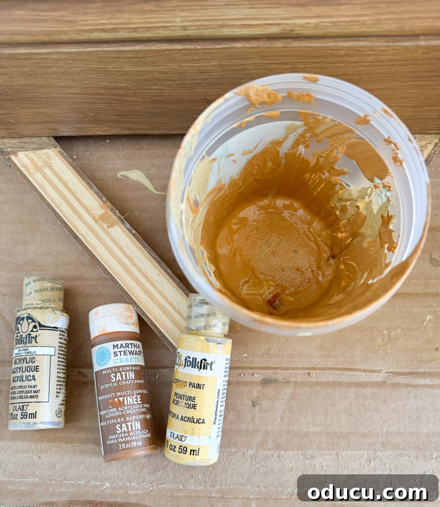 The Transformed Cabinets 6 Mixing clear glazing medium with gold and yellow acrylic paints to create a base for faux wood finish