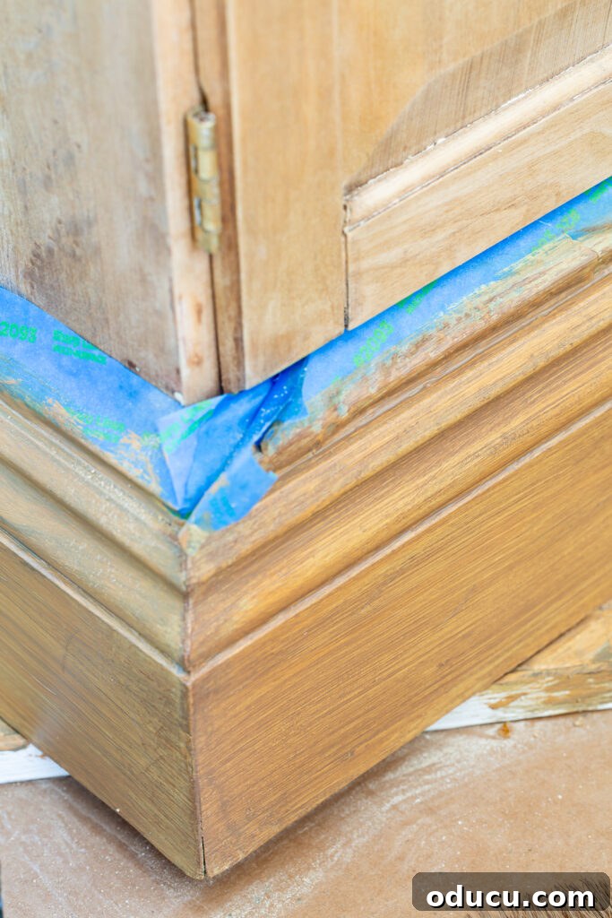 The Transformed Cabinets 10 Refining faux wood grain with a second layer of brown glaze, wiping off excess for depth and realism