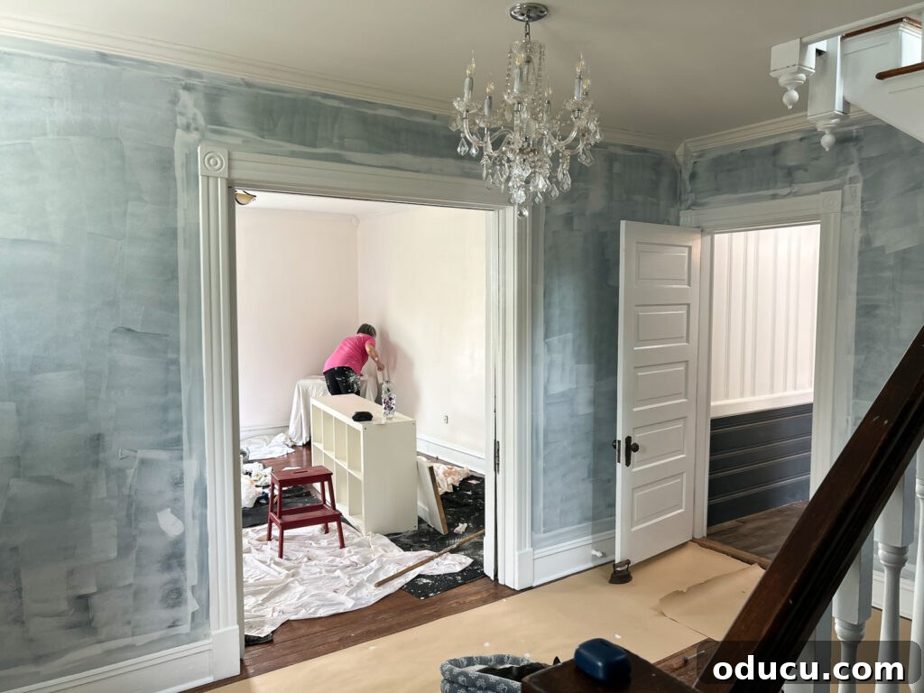 Actively painting walls in a living room, illustrating the hands-on work.