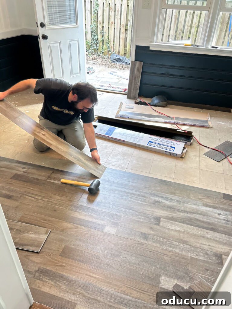 Detailed shot of new flooring being installed in the sunroom.