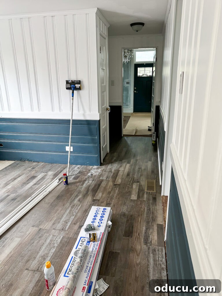 New LVP flooring being meticulously installed in the sunroom.
