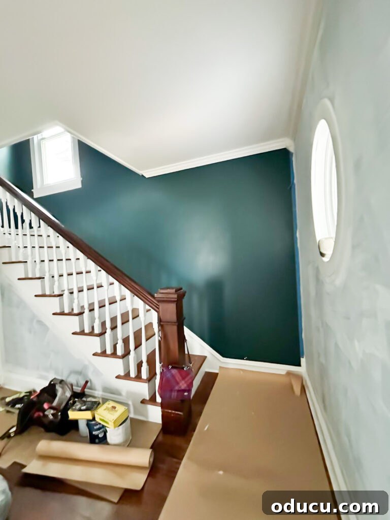 Dark green walls in the foyer of the new home.