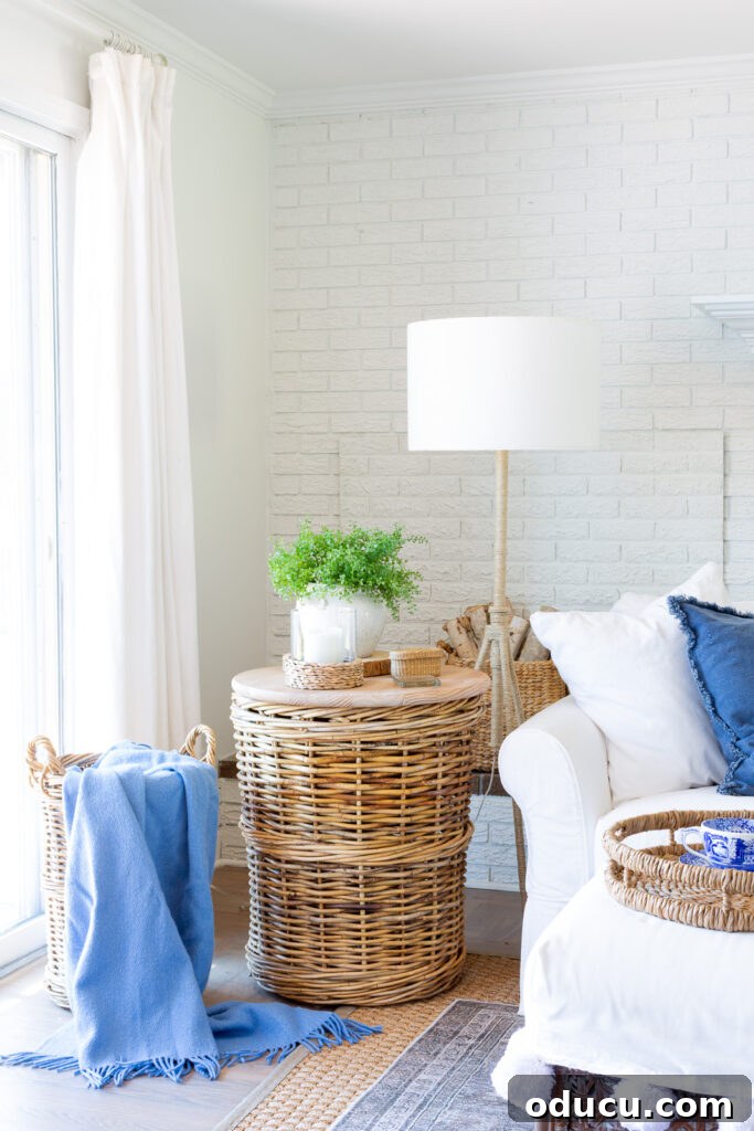 A charming basket side table adds character to a blue and white decorated living room, perfect for summer.