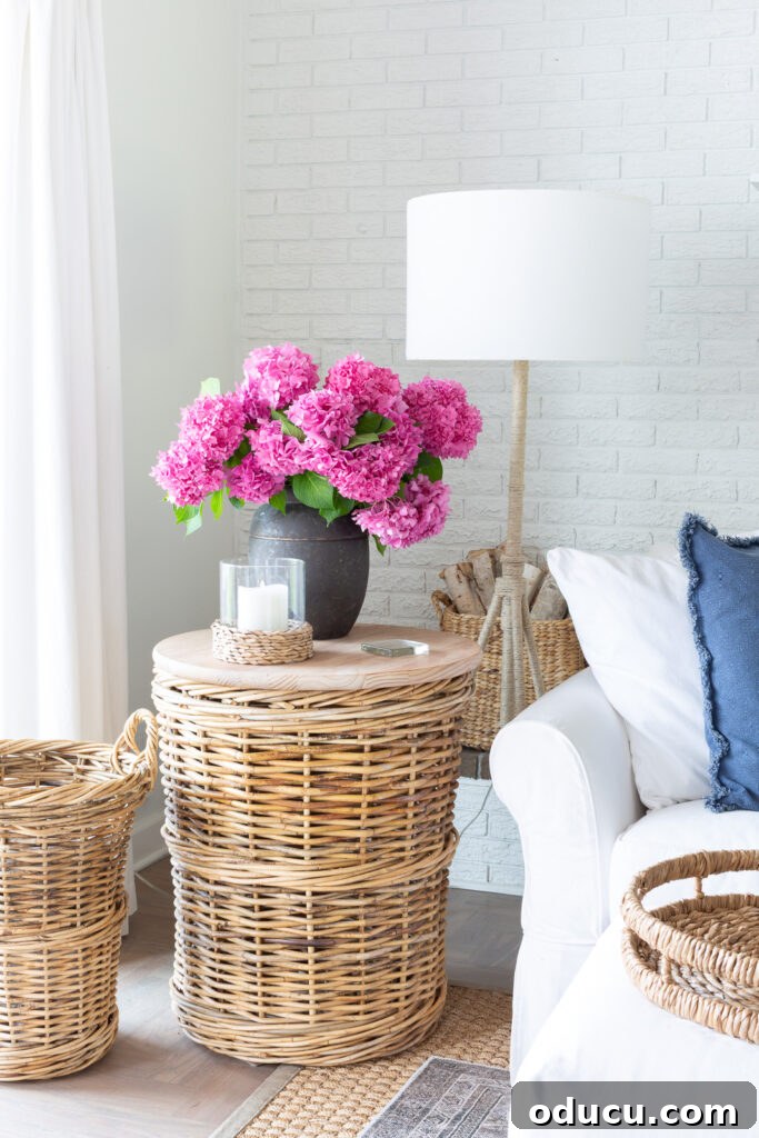 Unlocking Stunning Decor Inspiration For Free 2 white and blue living room with pink hydrangeas in a black planter, highlighting a chic home decor transformation