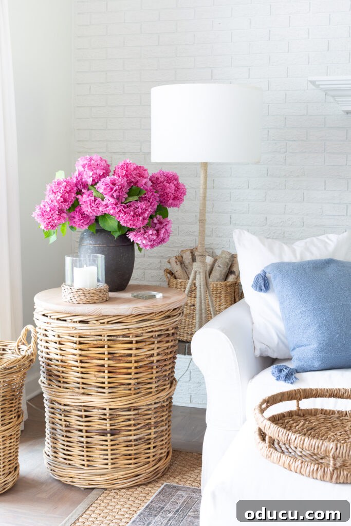 Unlocking Stunning Decor Inspiration For Free 15 White and blue living room featuring pink hydrangeas beautifully arranged in a stylish black planter, illustrating a sophisticated decor tip