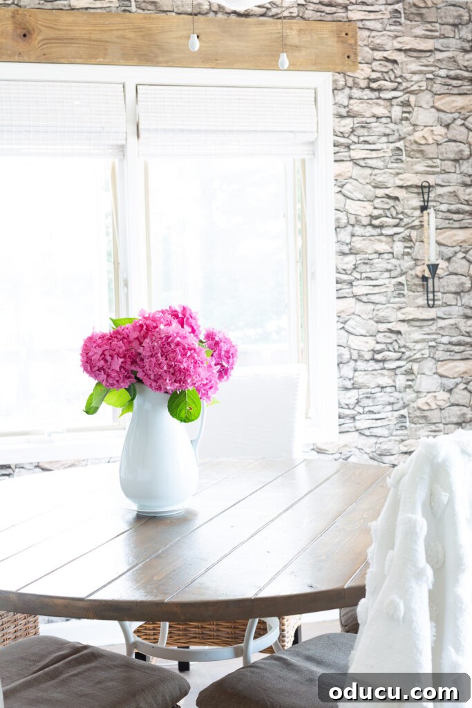 Unlocking Stunning Decor Inspiration For Free 3 pink hydrangeas in a white pitcher on a rustic wood kitchen table, a traditional decor choice