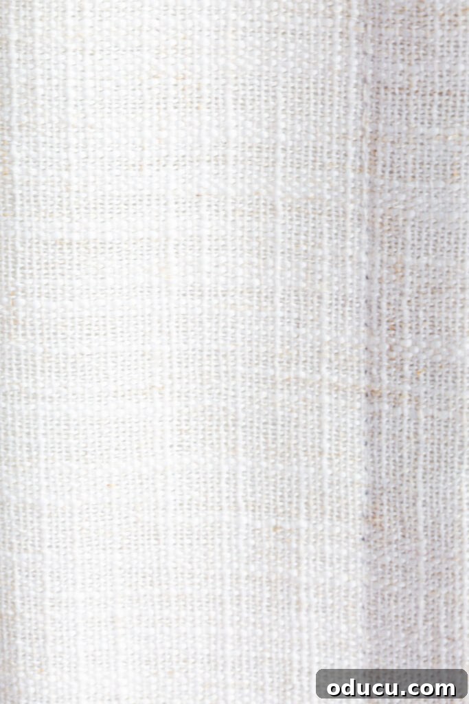 THY Curtains Adorn Every Space Beautifully 14 A close-up view highlighting the exquisite texture and weave of the LIZ Linen Drapes from TwoPages, revealing their premium quality.