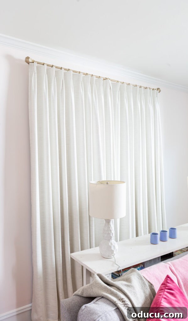 THY Curtains Adorn Every Space Beautifully 18 Twopages Ready Made Liz Linen Drapery Pinch Pleat with Blackout Lining in Ivory White (52W x 96L), gracefully closed on a window, demonstrating full coverage and elegant drape.