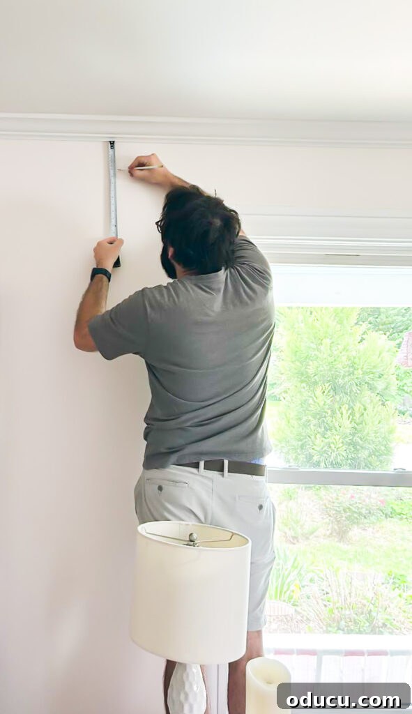 THY Curtains Adorn Every Space Beautifully 6 Measuring the wall around a window to accurately determine the ideal curtain rod placement for optimal aesthetics.
