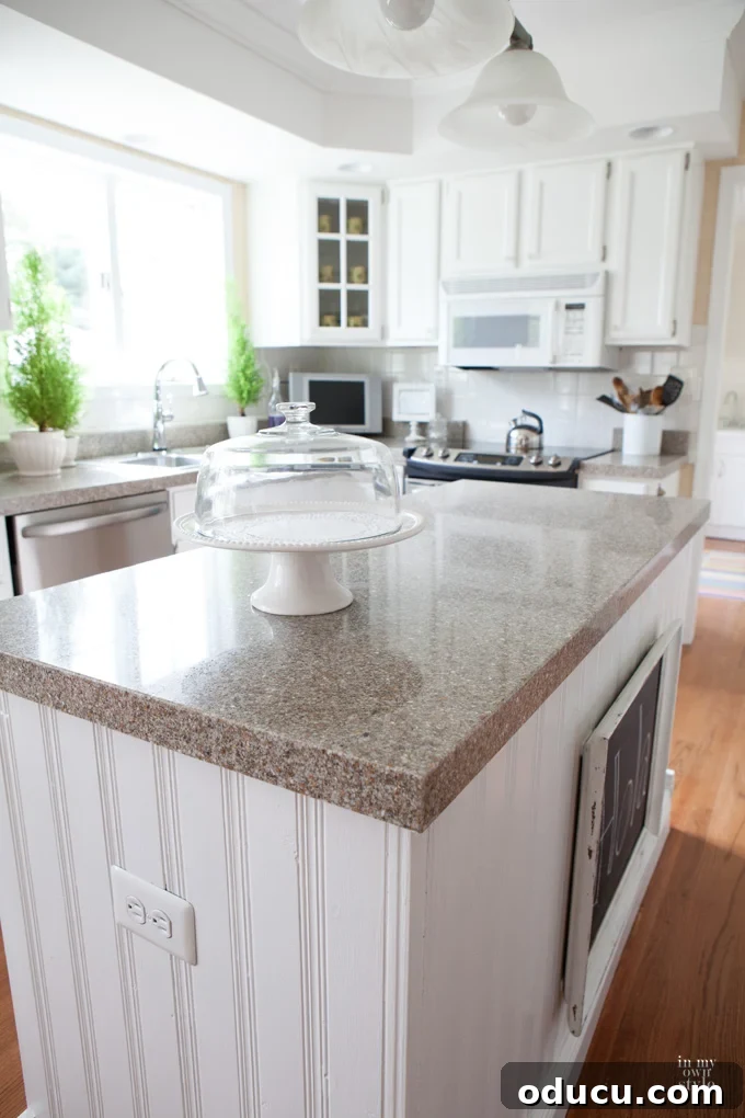 My Kitchen's New Centerpiece 2 A beautifully redesigned kitchen island with beadboard paneling and seamless molding, showcasing a clean, modern aesthetic after a significant upgrade.