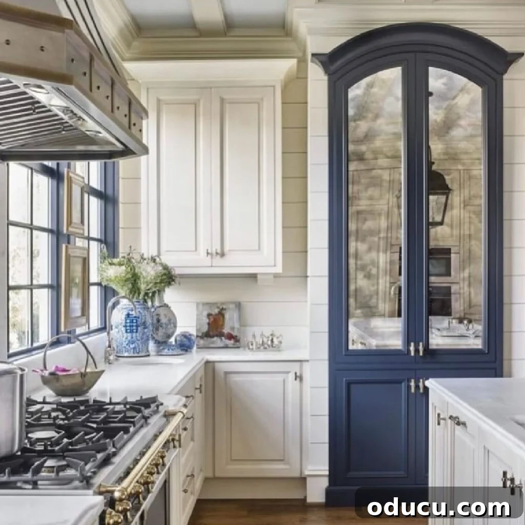 My Kitchen's New Centerpiece 4 A luxurious and inviting blue and white kitchen, expertly designed by Matthew Quinn, featuring elegant cabinetry and modern fixtures.