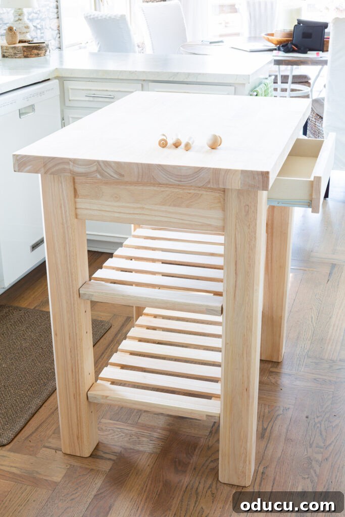 My Kitchen's New Centerpiece 5 A pristine 24 x 36 solid wood kitchen island from Wayfair, showcased in its natural, unpainted state, ready for customization.