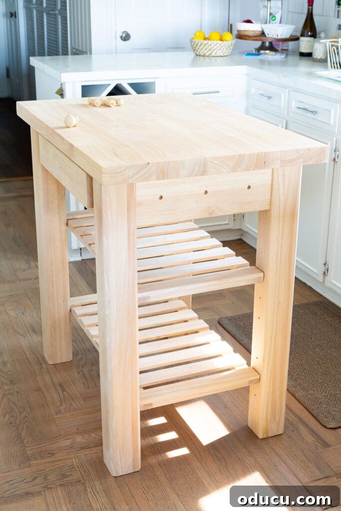 My Kitchen's New Centerpiece 6 The unfinished 24 x 36 solid wood kitchen island from Wayfair, thoughtfully placed in a kitchen setting and awaiting its final paint treatment.