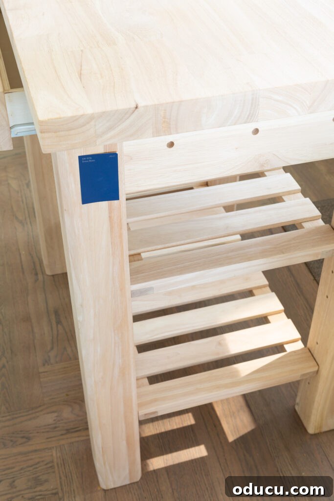Sturdy solid wood portable kitchen island before painting, showcasing two slatted shelves