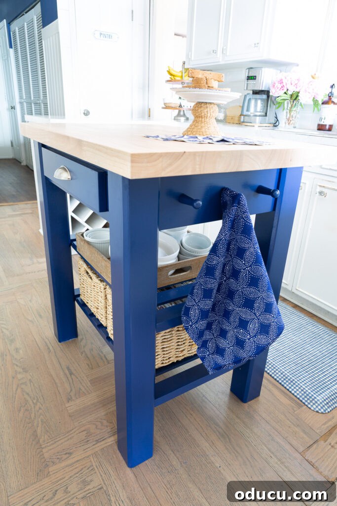 After photo of the newly painted kitchen island in Sherwin Williams Dress Blues, showcasing its finished look.