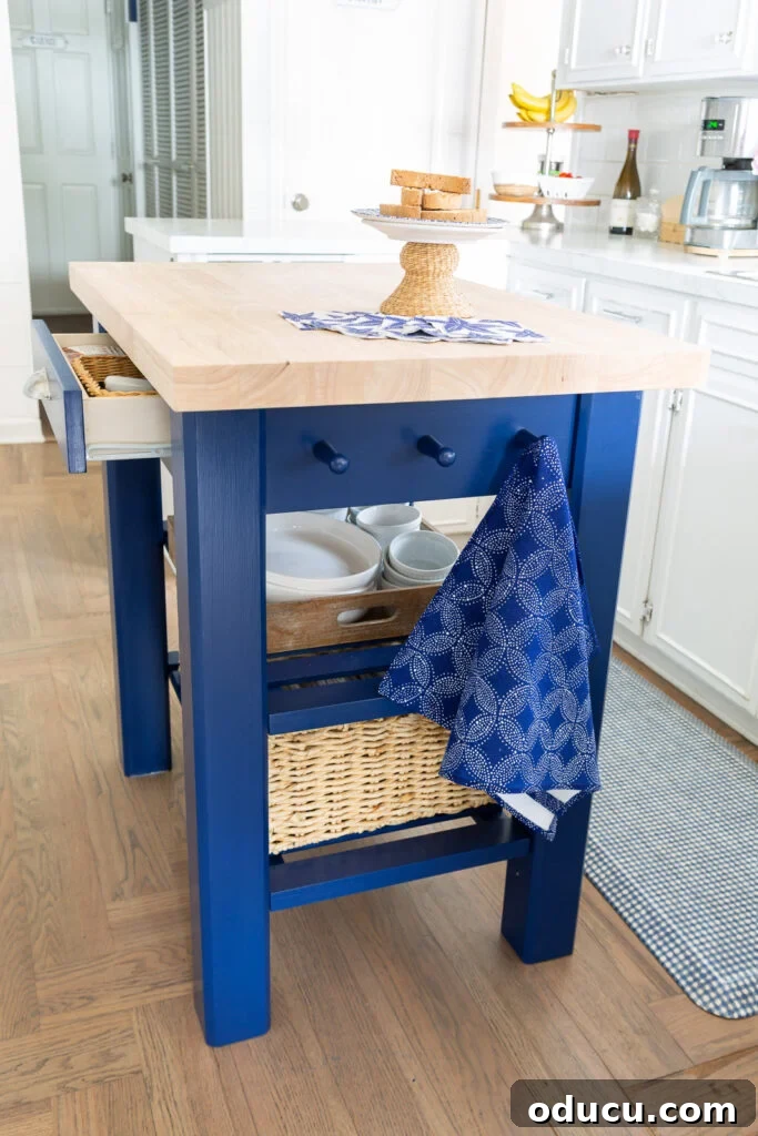 Side view of the newly painted portable kitchen island from Wayfair, showcasing its rich blue finish in a home kitchen setting.