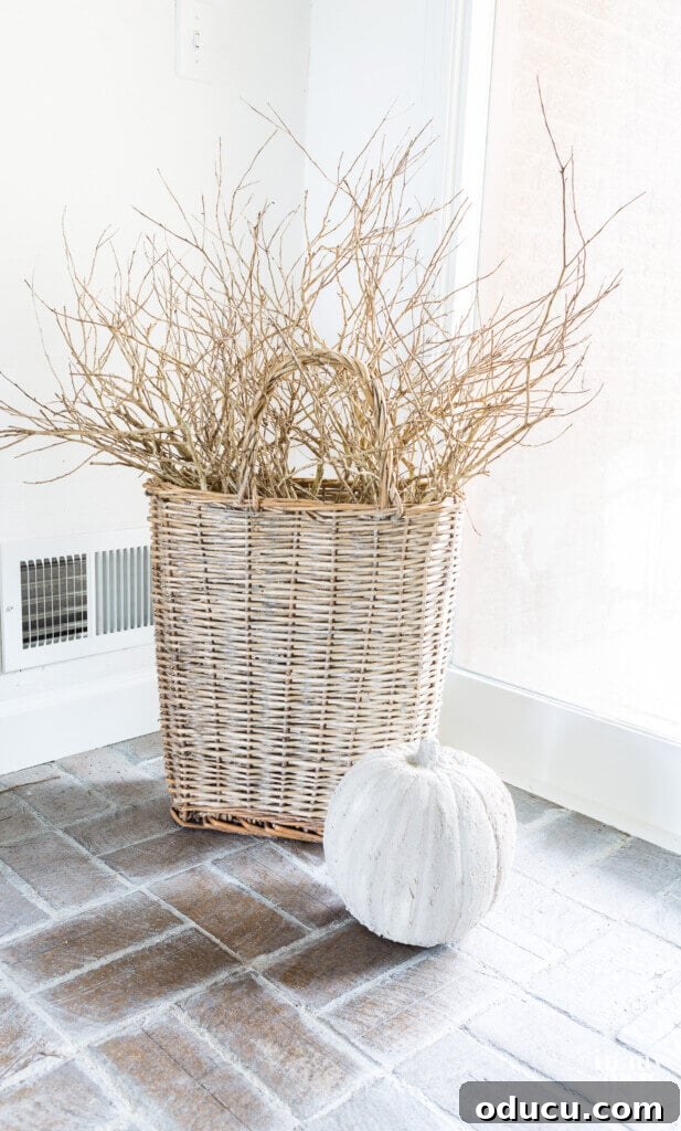 Fall Decor Reimagined 24 Tall handled basket with stone pumpkin in front of it.