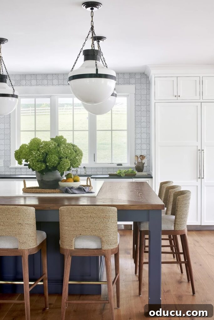 Trendspotting 255 2 White kitchen with blue accents. A bright and airy kitchen space featuring white cabinetry, a large island, and subtle blue decorative elements that add a touch of color and sophistication.