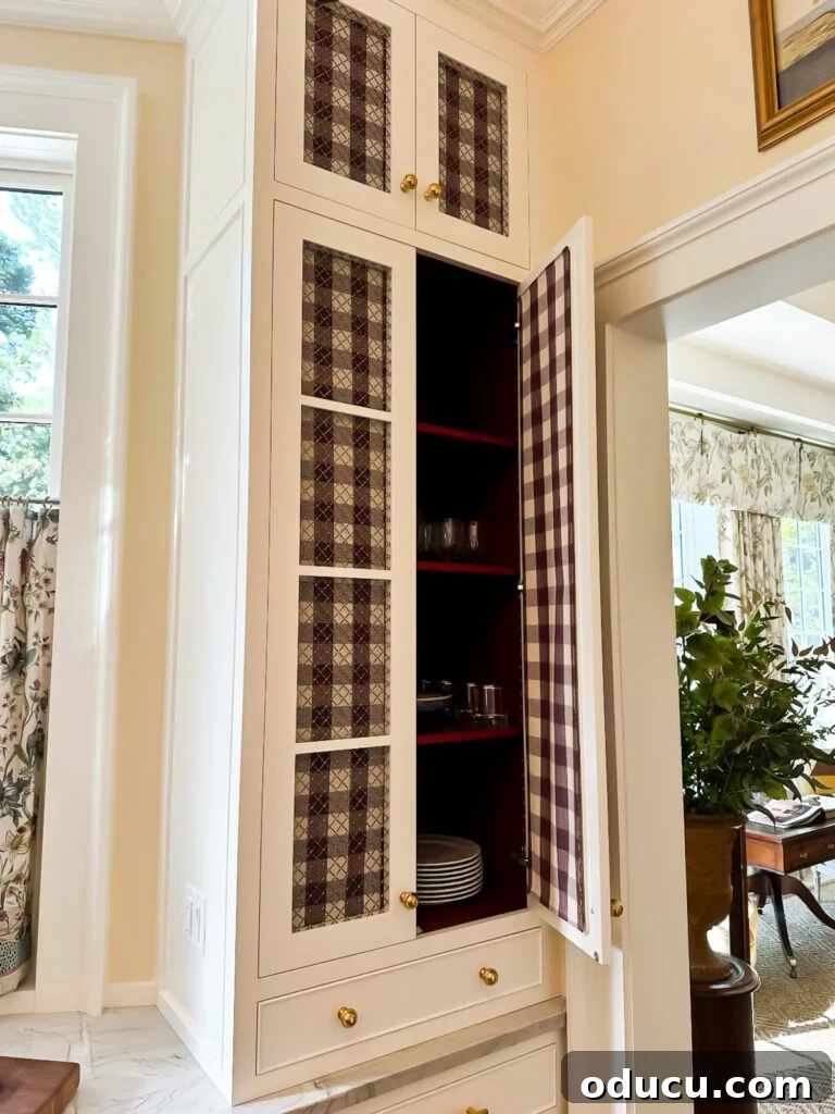 Shaping Tomorrow's Home: Inside the Southern Living Idea House 2025 15 fabric covered glass fronted cabinets in kitchen at the SL Idea House 2025