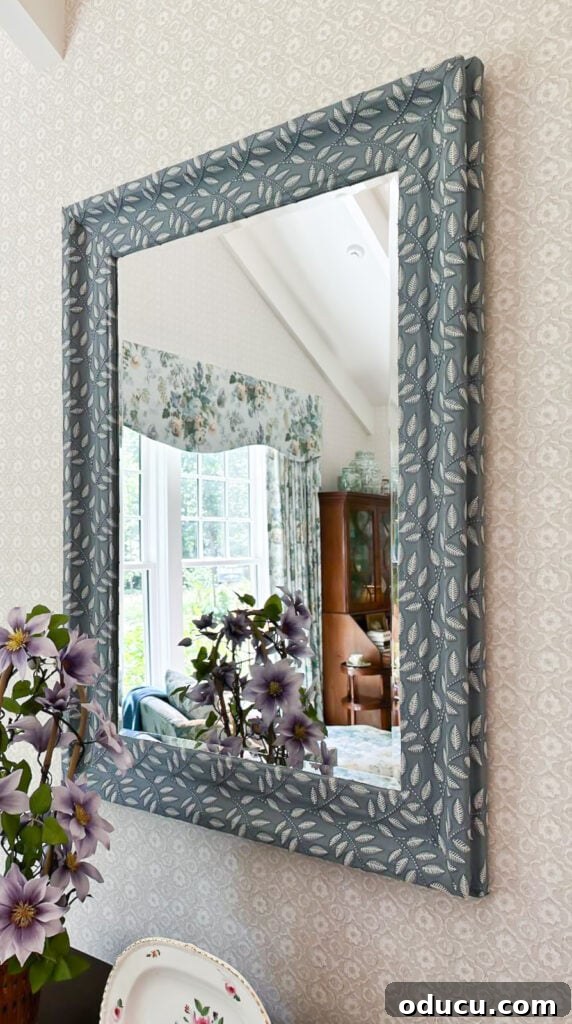 Shaping Tomorrow's Home: Inside the Southern Living Idea House 2025 30 textured woven fabric covering the frame of a mirror in a bedroom