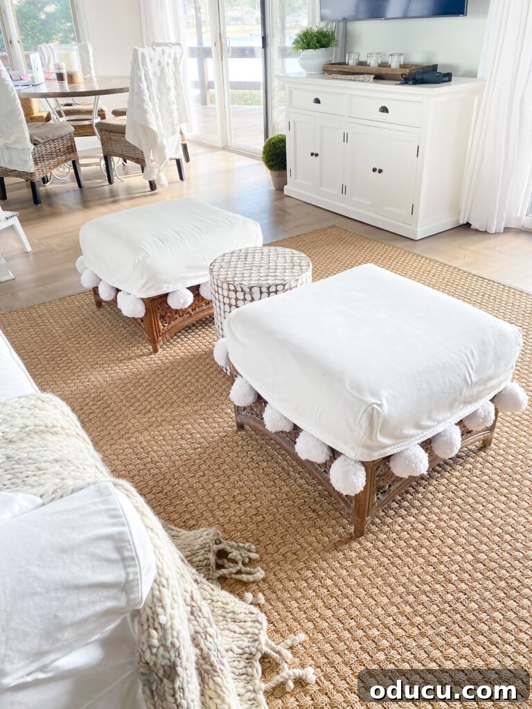 Remember That Essential Decorating Resource 19 two square rattan ottomans with large pom-pom trimmed cushions in a living room.